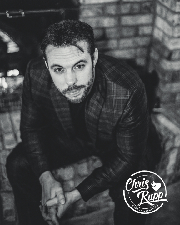 A black-and-white portrait of Chris Rupp